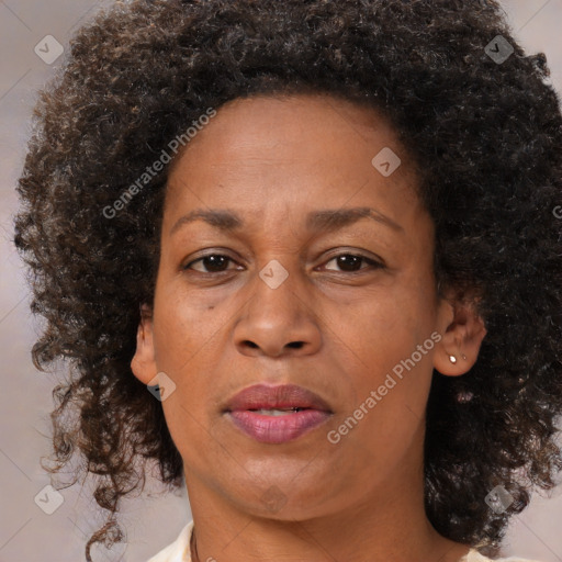 Joyful black adult female with medium  brown hair and brown eyes