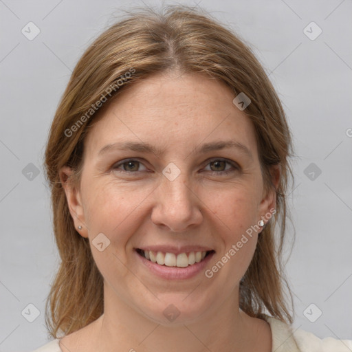 Joyful white adult female with medium  brown hair and grey eyes