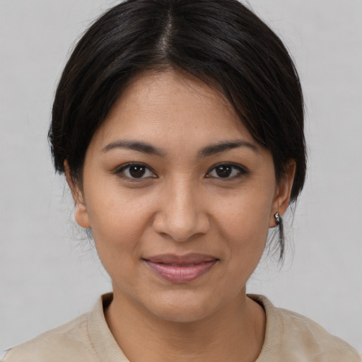 Joyful asian young-adult female with medium  brown hair and brown eyes