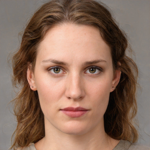 Joyful white young-adult female with medium  brown hair and green eyes