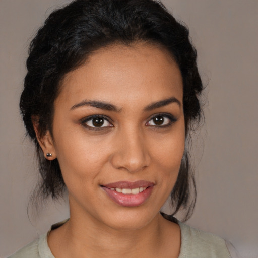 Joyful latino young-adult female with medium  brown hair and brown eyes