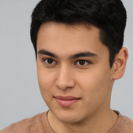 Joyful latino young-adult male with short  brown hair and brown eyes