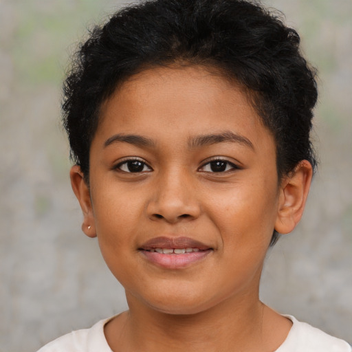 Joyful latino child female with short  brown hair and brown eyes