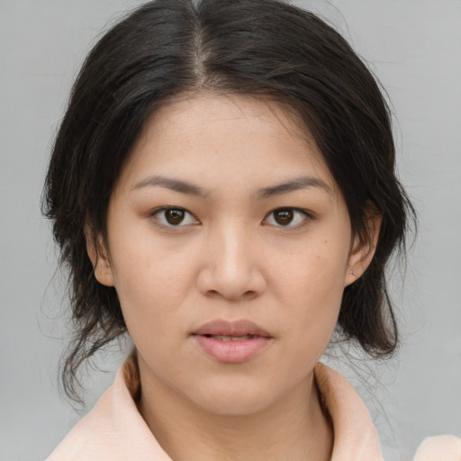 Joyful asian young-adult female with medium  brown hair and brown eyes