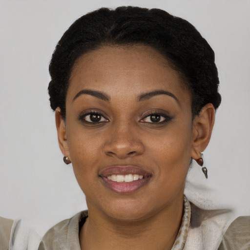 Joyful black young-adult female with short  black hair and brown eyes