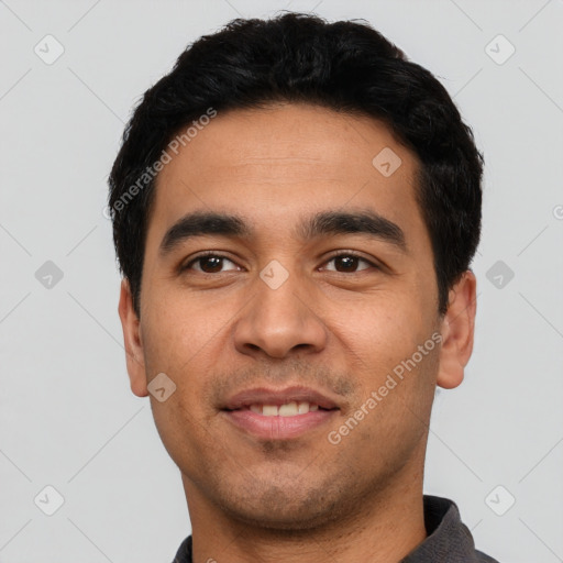 Joyful latino young-adult male with short  black hair and brown eyes