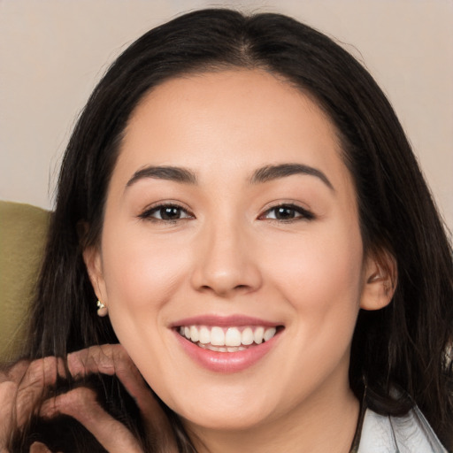 Joyful white young-adult female with long  black hair and brown eyes