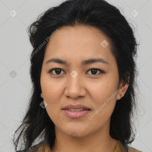 Joyful latino young-adult female with long  brown hair and brown eyes