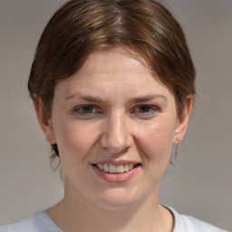 Joyful white young-adult female with medium  brown hair and blue eyes