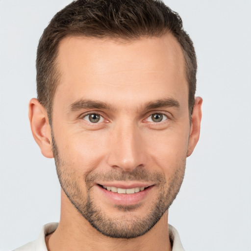 Joyful white young-adult male with short  brown hair and brown eyes