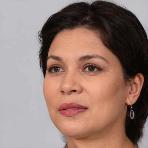 Joyful white adult female with medium  brown hair and brown eyes