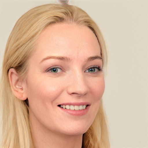 Joyful white young-adult female with long  blond hair and blue eyes