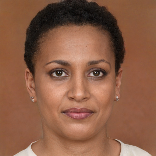 Joyful black young-adult female with short  brown hair and brown eyes