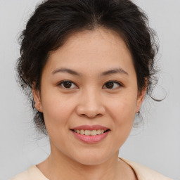 Joyful asian young-adult female with medium  brown hair and brown eyes