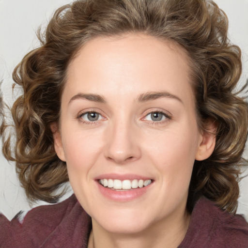 Joyful white young-adult female with medium  brown hair and green eyes