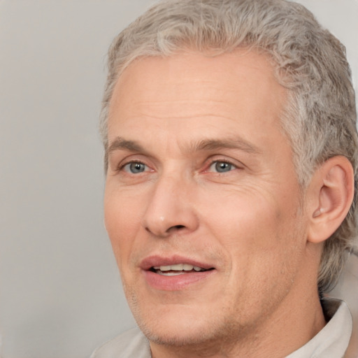 Joyful white adult male with short  brown hair and grey eyes