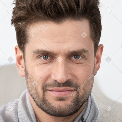 Joyful white adult male with short  brown hair and brown eyes