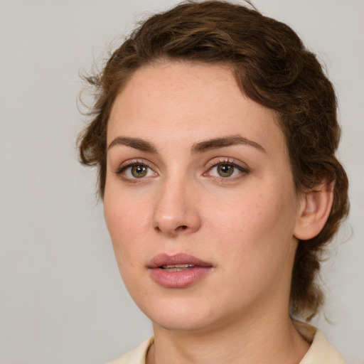 Joyful white young-adult female with medium  brown hair and green eyes