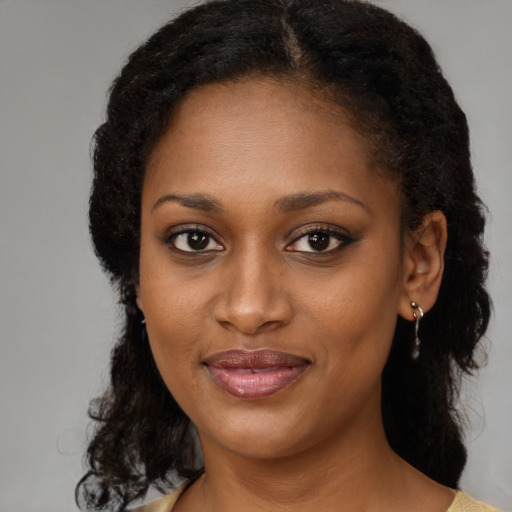 Joyful black young-adult female with medium  brown hair and brown eyes