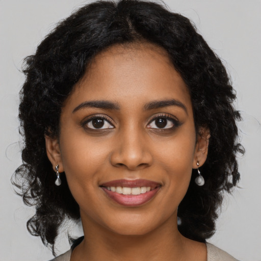 Joyful black young-adult female with medium  black hair and brown eyes