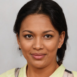 Joyful black young-adult female with medium  brown hair and brown eyes