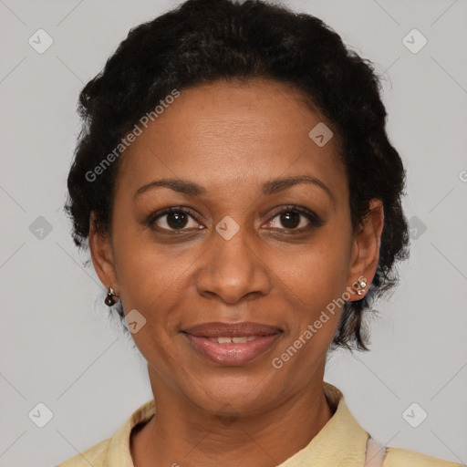 Joyful black adult female with short  brown hair and brown eyes