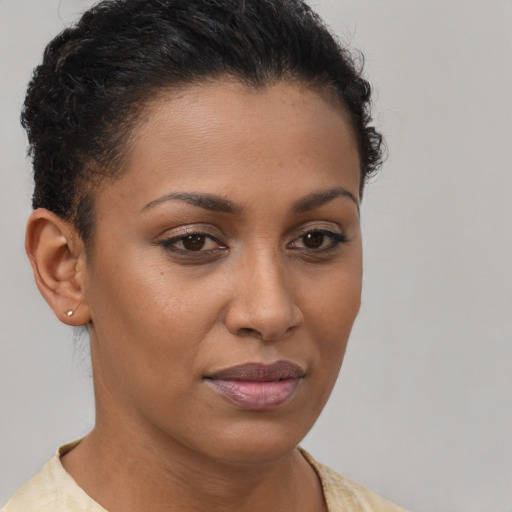 Joyful black young-adult female with short  brown hair and brown eyes