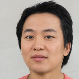 Joyful asian young-adult male with short  black hair and brown eyes