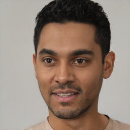 Joyful latino young-adult male with short  black hair and brown eyes