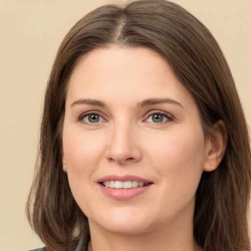 Joyful white young-adult female with long  brown hair and brown eyes