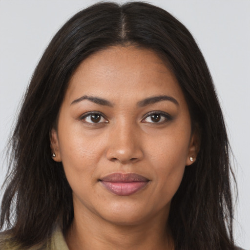 Joyful latino young-adult female with long  brown hair and brown eyes