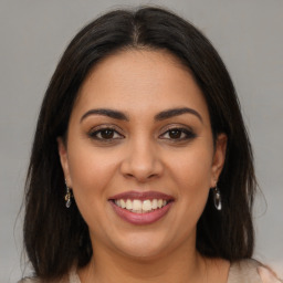 Joyful latino young-adult female with medium  brown hair and brown eyes