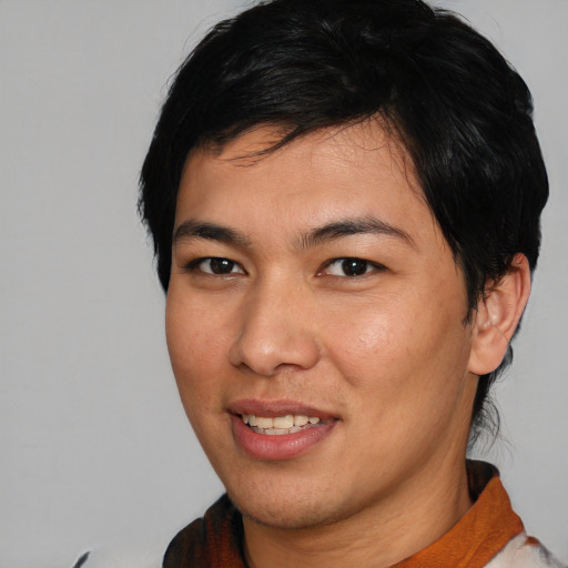 Joyful asian young-adult male with short  brown hair and brown eyes