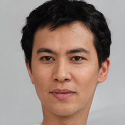 Joyful asian young-adult male with short  black hair and brown eyes