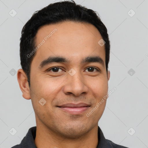 Joyful latino young-adult male with short  black hair and brown eyes