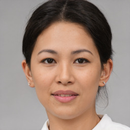 Joyful asian young-adult female with medium  brown hair and brown eyes