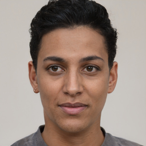Joyful latino young-adult female with short  black hair and brown eyes
