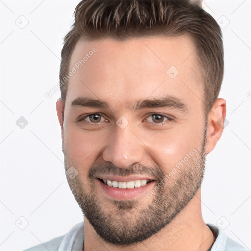 Joyful white young-adult male with short  brown hair and brown eyes