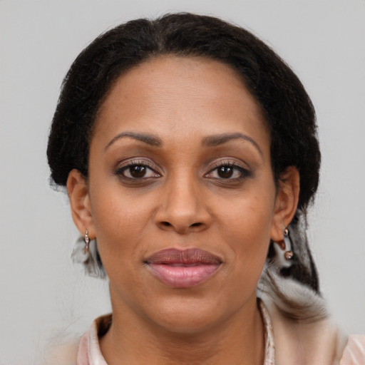 Joyful latino adult female with medium  brown hair and brown eyes