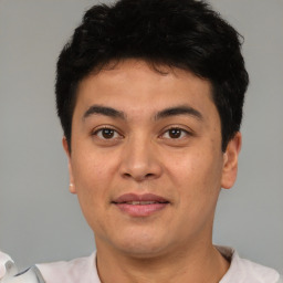 Joyful asian young-adult male with short  black hair and brown eyes