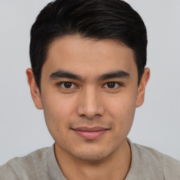 Joyful asian young-adult male with short  black hair and brown eyes