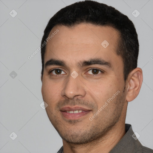 Joyful white young-adult male with short  black hair and brown eyes