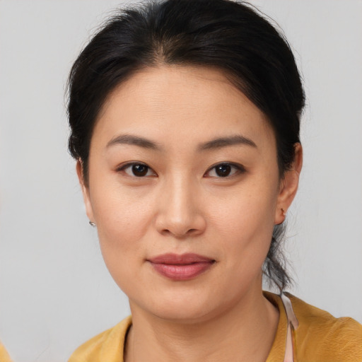 Joyful asian young-adult female with short  brown hair and brown eyes