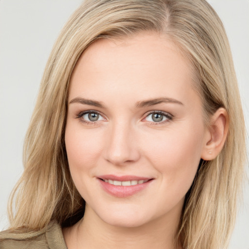 Joyful white young-adult female with long  brown hair and blue eyes