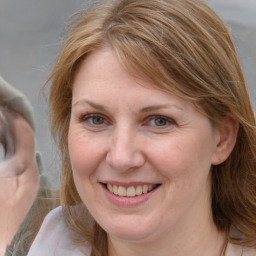 Joyful white adult female with medium  brown hair and blue eyes