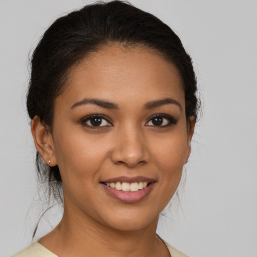 Joyful latino young-adult female with medium  brown hair and brown eyes