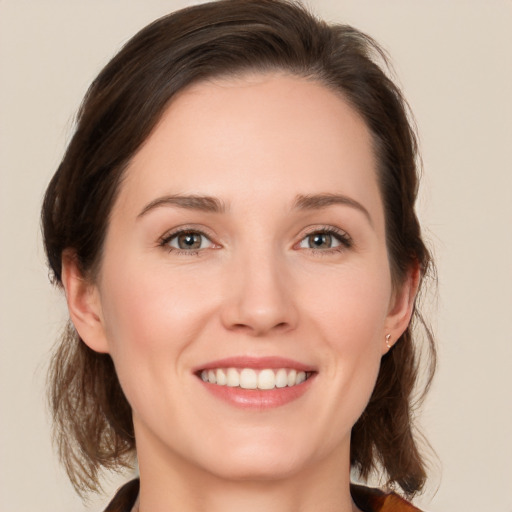 Joyful white young-adult female with medium  brown hair and brown eyes