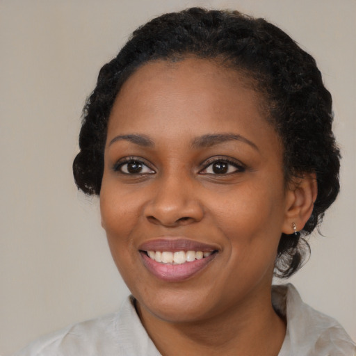 Joyful black young-adult female with medium  black hair and brown eyes