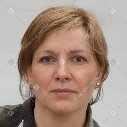 Joyful white adult female with medium  brown hair and grey eyes