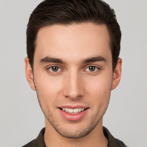 Joyful white young-adult male with short  brown hair and brown eyes